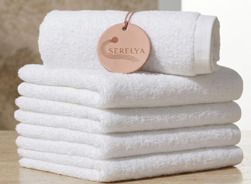Stack of white bath towels rolled and folded